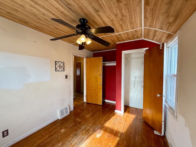 unfurnished bedroom featuring wood ceiling, visible vents, baseboards, and hardwood / wood-style flooring