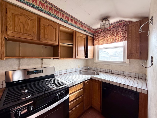 kitchen featuring tile counters, range with gas stovetop, dishwasher, open shelves, and a sink