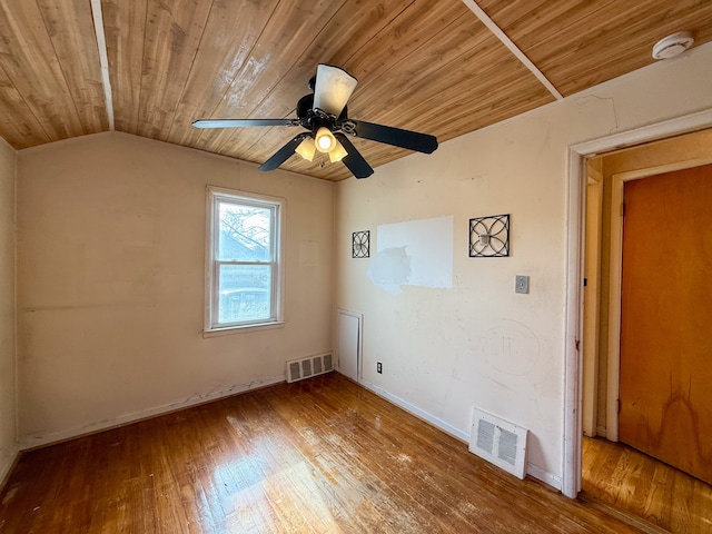 spare room featuring lofted ceiling, wooden ceiling, visible vents, and hardwood / wood-style flooring