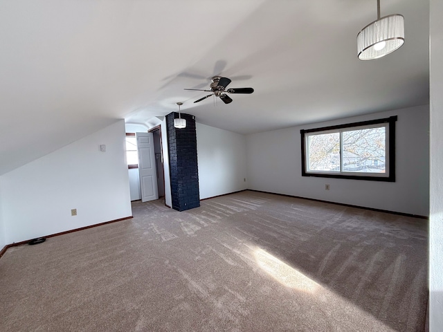 bonus room with lofted ceiling, a ceiling fan, baseboards, and carpet flooring