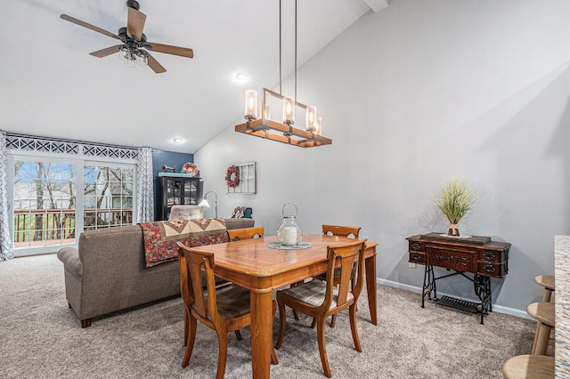 dining space featuring ceiling fan with notable chandelier, baseboards, vaulted ceiling, and light colored carpet