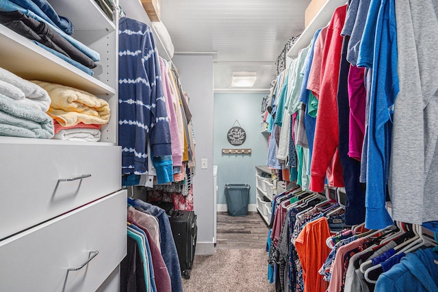 walk in closet with wood finished floors