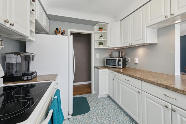 kitchen with electric stove, open shelves, stainless steel microwave, dark countertops, and white cabinets