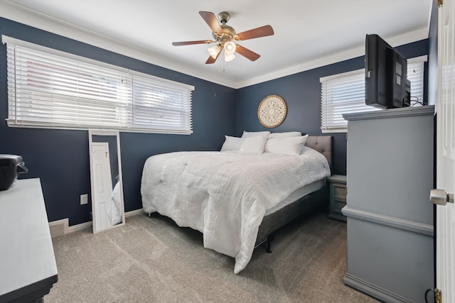 bedroom with multiple windows, a ceiling fan, baseboards, and carpet floors