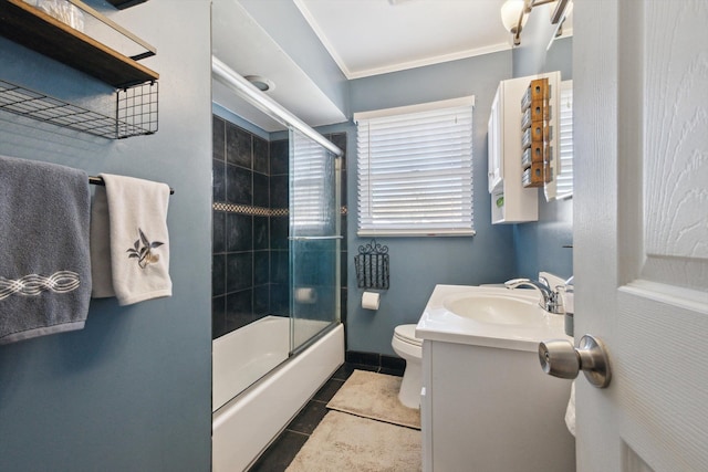 full bath featuring toilet, ornamental molding, tile patterned flooring, enclosed tub / shower combo, and vanity