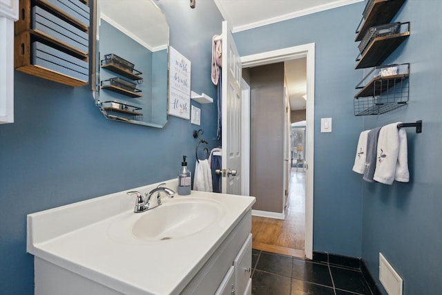 bathroom featuring vanity, tile patterned floors, baseboards, and visible vents