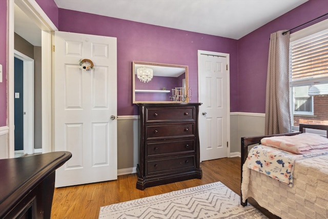 bedroom featuring wood finished floors and baseboards