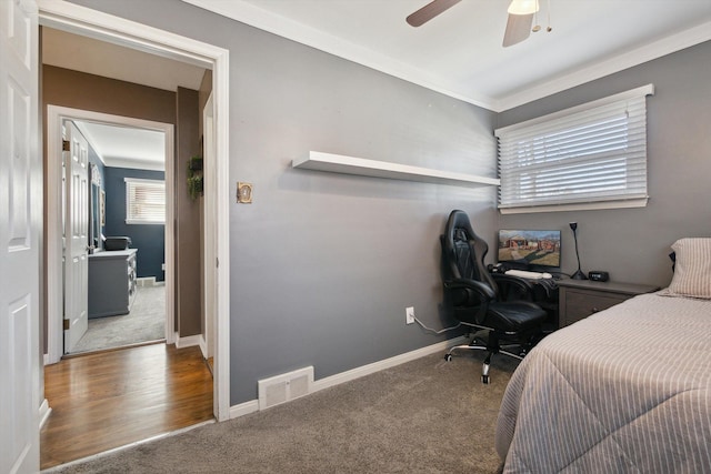 carpeted bedroom featuring visible vents, baseboards, and ceiling fan