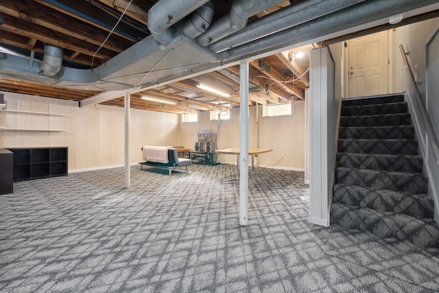 below grade area featuring stairs and carpet floors