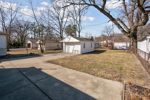 view of yard featuring an outdoor structure and fence