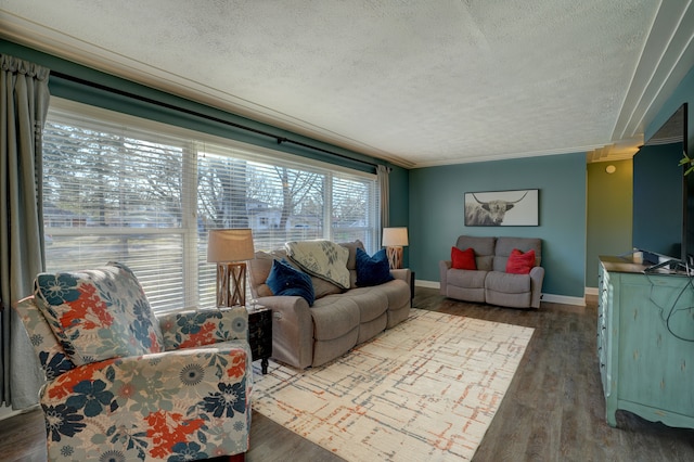 living room featuring a textured ceiling, crown molding, baseboards, and dark wood-style flooring