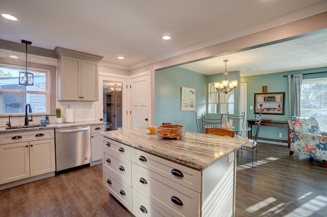 kitchen with light stone counters, dark wood finished floors, a sink, dishwasher, and tasteful backsplash