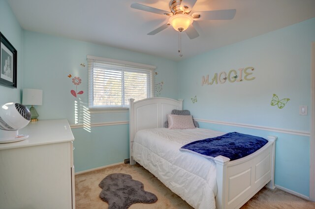 bedroom featuring baseboards, light carpet, and a ceiling fan