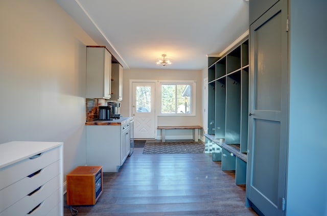 mudroom featuring a notable chandelier and dark wood-style floors