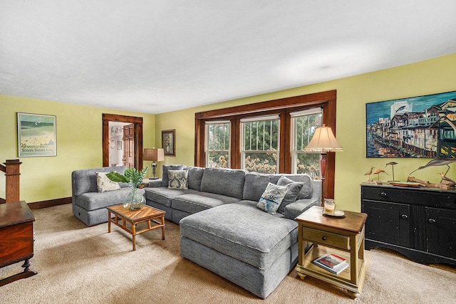 living area featuring carpet and baseboards