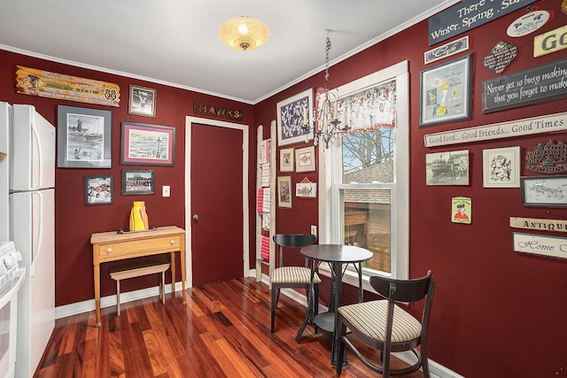 dining space featuring crown molding, baseboards, and dark wood-type flooring