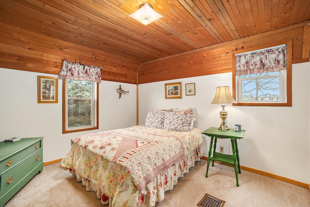 carpeted bedroom with wood ceiling, multiple windows, and baseboards