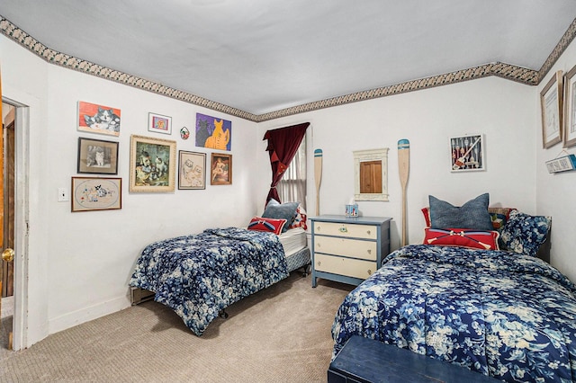 carpeted bedroom with baseboards and vaulted ceiling