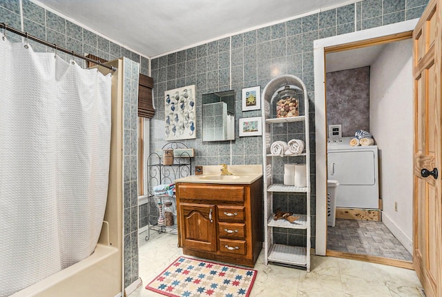 bathroom with washer / dryer, shower / tub combo with curtain, marble finish floor, vanity, and tile walls