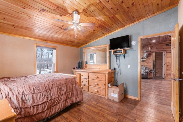 bedroom with baseboards, lofted ceiling, wooden ceiling, ceiling fan, and wood finished floors