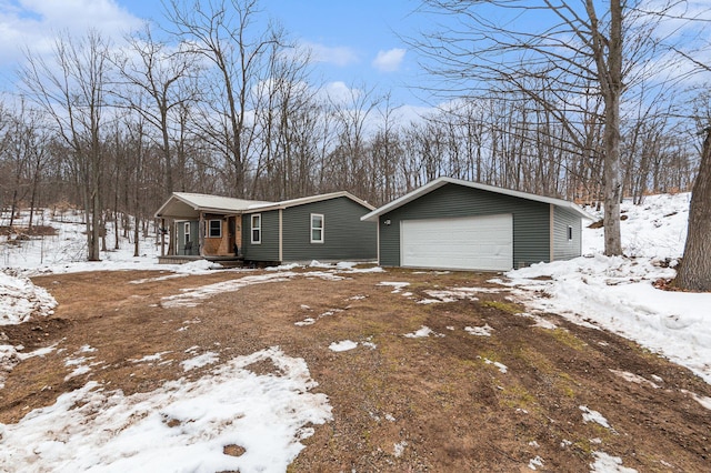 view of front of house featuring a detached garage and an outdoor structure