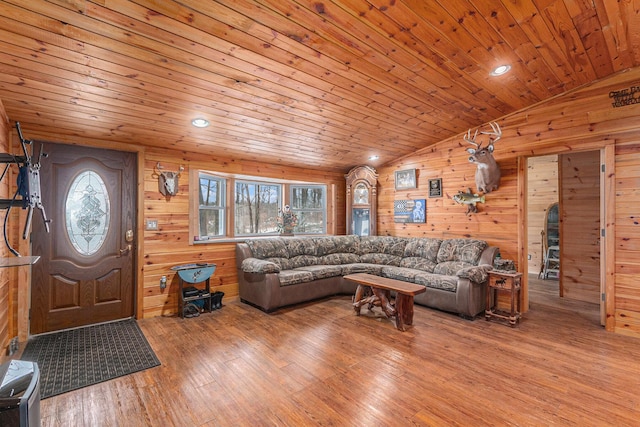 living room featuring wooden ceiling, vaulted ceiling, wood walls, and wood finished floors