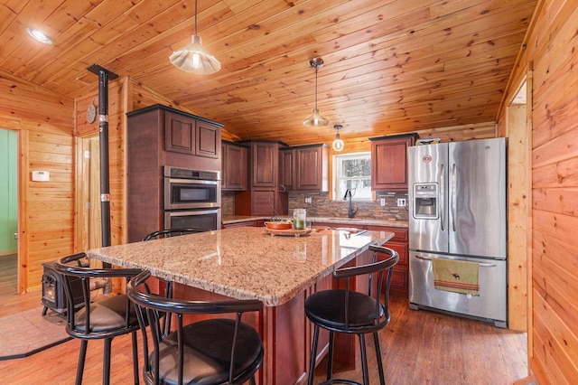 kitchen featuring a sink, appliances with stainless steel finishes, wooden ceiling, and wood finished floors