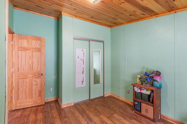 bedroom featuring wood finished floors, wood ceiling, and baseboards