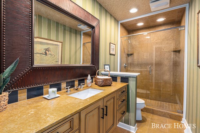 full bath featuring recessed lighting, toilet, a shower stall, vanity, and tile patterned flooring