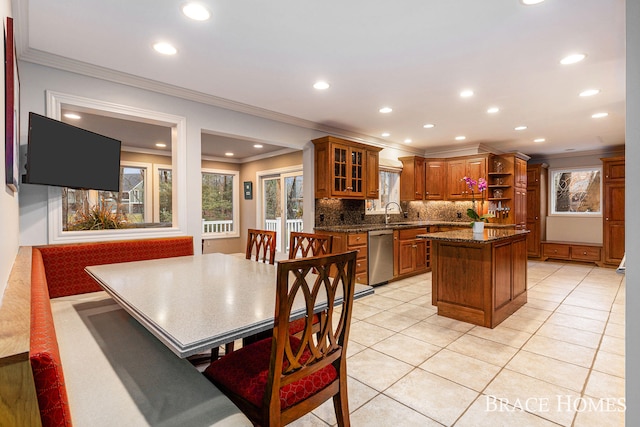 kitchen featuring light tile patterned flooring, stainless steel dishwasher, backsplash, open shelves, and brown cabinetry