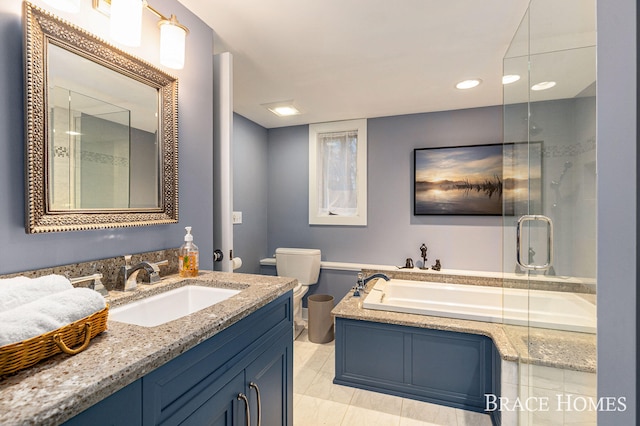 bathroom with a bath, a shower stall, toilet, and vanity