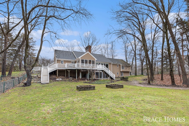 back of property featuring a yard, a fenced backyard, stairs, and a wooden deck