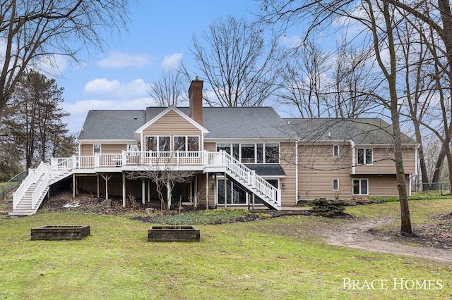 rear view of property featuring stairs, a chimney, a deck, and a lawn