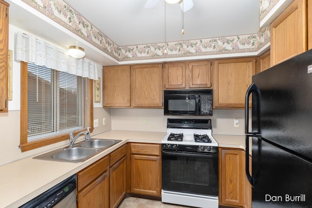 kitchen with light countertops, a sink, and black appliances