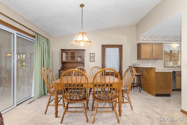 dining room with light carpet and lofted ceiling