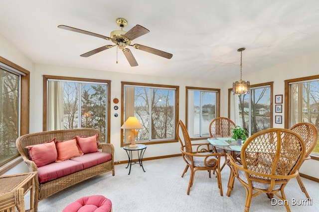 dining room with baseboards, ceiling fan, and light colored carpet