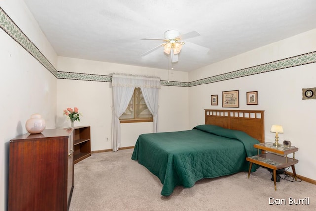 carpeted bedroom featuring a ceiling fan and baseboards