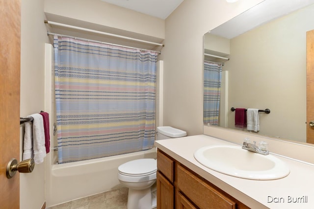 bathroom featuring toilet, shower / bath combo with shower curtain, and vanity