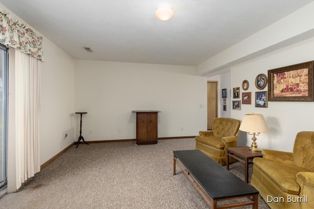 living area with visible vents, baseboards, and carpet flooring