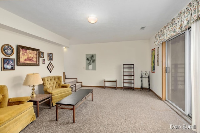 living area featuring carpet and baseboards