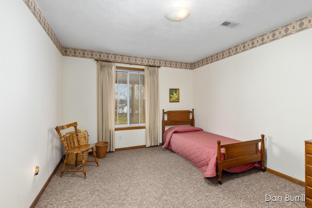 carpeted bedroom featuring baseboards and visible vents