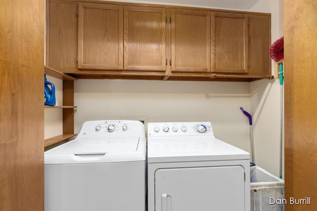 washroom with washing machine and clothes dryer and cabinet space