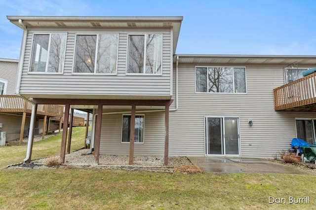 rear view of house with a patio area and a lawn