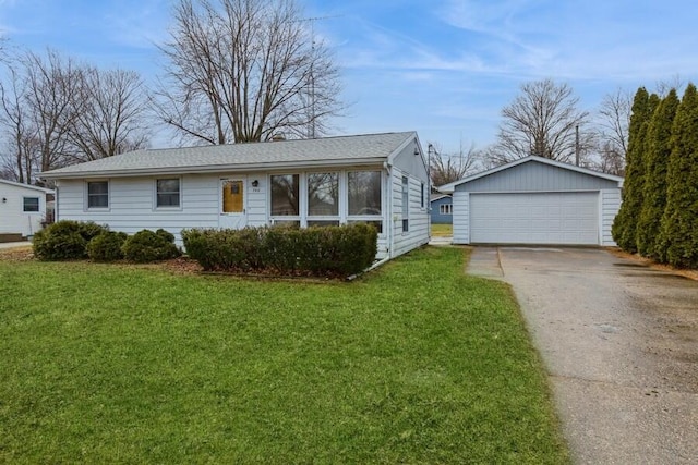 single story home featuring an outbuilding, a front yard, and a garage