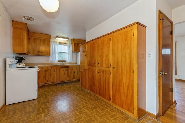 kitchen featuring a sink, baseboards, light countertops, brown cabinetry, and white electric range oven