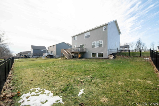 back of house with a fenced backyard, a lawn, a wooden deck, and stairs