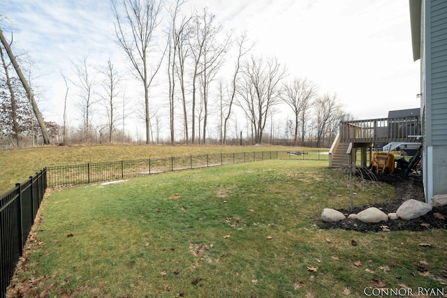 view of yard with stairway, a fenced backyard, and a wooden deck