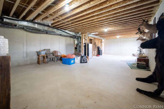 unfinished basement featuring water heater