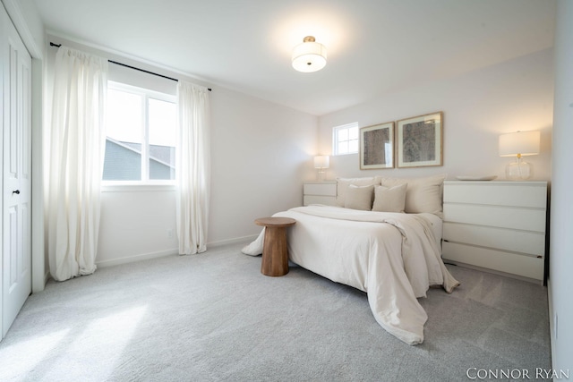 bedroom featuring carpet and baseboards