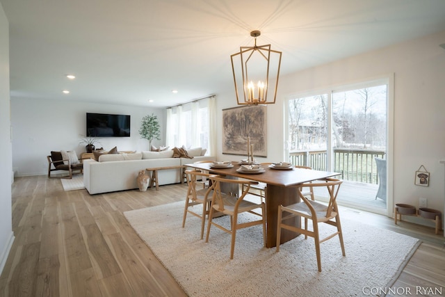 dining room with a chandelier, light wood finished floors, and recessed lighting